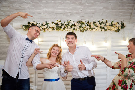 Kirov, RUSSIA - July 18, 2020: Photo of bride and groom at the registry office after the official marriage ceremony with people, friends, relatives, guests congratulating them on their weddingのeditorial素材