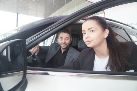 Kirov, Russia - April 12, 2022: Manager seller and buyer in showroom with cars of dealership Nissan in city Kirovのeditorial素材