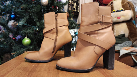 Red or brown boots on a flat surface during garage sale. old shoes for sale