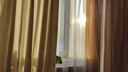 Curtain with tulle on the window. The interior of the room with draped curtainsの写真素材