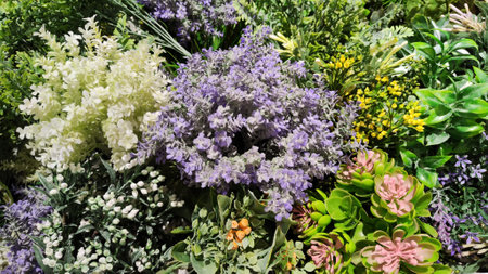 Mixed colorful flowers background. Vibrant colors of mixed flowers backdrop. Texture with flowers and colorの写真素材