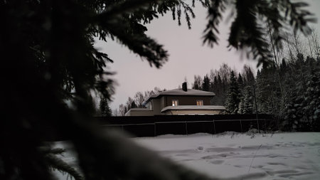 Small rural or rustic house or cottage in the woods late at night or at night in winterの写真素材