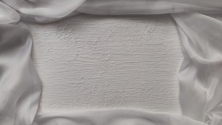 Abstract background with a light delicate white fabric chiffon creating frame around square with...