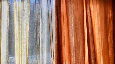 White tulle curtain and other sun curtain hung on window with sun. Abstract texture and background for frameの写真素材