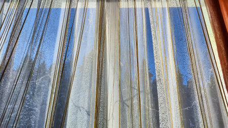 White tulle curtain and other sun curtain hung on window with sun. Abstract texture and background for frameの写真素材