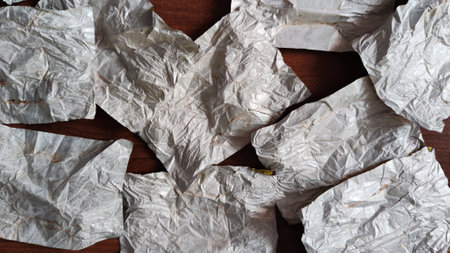 Pieces of crumpled silver foil sheets. Close up. Abstract background and textureの写真素材