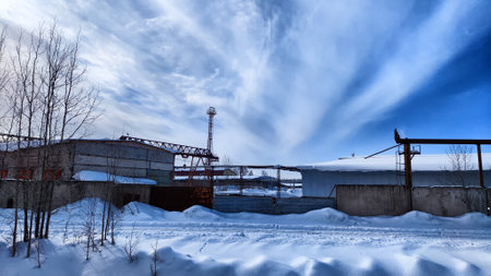 Abandoned Industrial Buildings in winter day and sky with white clouds on the Backgroundの写真素材