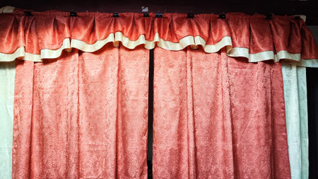 Red fabric with abstract texture for background, close-up. Small pattern on curtain lambrequinの写真素材