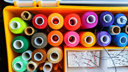 Storage box with spools of multi-colored threads, sewing needles. Storage system for sewing needlework at home and officeの写真素材