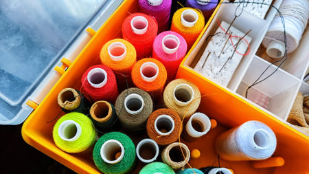 Storage box with spools of multi-colored threads, sewing needles. Storage system for sewing needlework at home and officeの写真素材