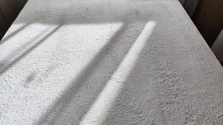 Abstract pattern with stripes and lines of shadow and light from sun on textured white whitewash, plaster, paint. background and textureの写真素材