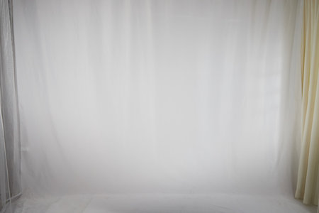White fabric background and light curtains. Location, frame for shooting in photo studio. Theater stage for backstage performancesの写真素材