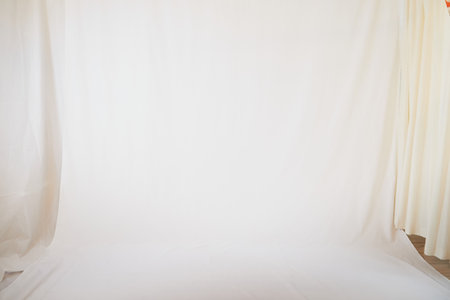 White fabric background and light curtains. Location, frame for shooting in photo studio. Theater stage for backstage performancesの写真素材
