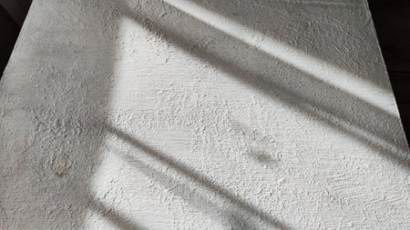 Abstract pattern with stripes and lines of shadow and light from sun on textured white whitewash,...