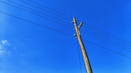 Power line pole on blue sky backgroundの写真素材