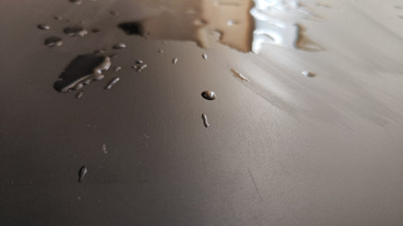 Water drops on black plastic. Surface wet background. Abstract texture and pattern full of water. Raindrops of rain for overlaying on window with partial focus. concept of autumn weatherの写真素材