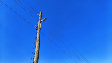 Power line pole on blue sky backgroundの写真素材