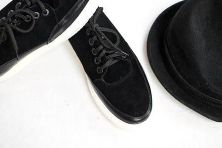 Fashionable suede sneakers. Sport shoes. Expensive footwear or loafers isolated on white background with different things. Professional photoshootの写真素材