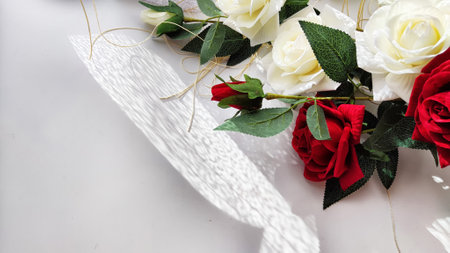 Background and texture with beautiful white and red roses with light and shadow from sun. Abstract cart with frame framed with roses, copy space and place for text. Concept of gifts, beauty, holidayの写真素材