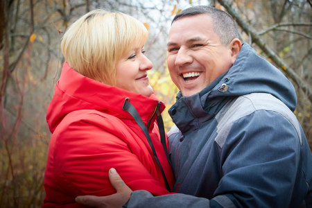 Kirov, Russia - October 23, 2022: Caucasian ordinary but cute couple with a plump woman and man in an autumn park or forest. The concept of love and tenderness in adulthoodのeditorial素材