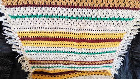 Knitted fabric with stripes of white, brown, yellow, and green colors. Abstract background, texture, frame and patternの写真素材