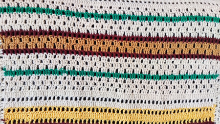Knitted fabric with stripes of white, brown, yellow, and green colors. Abstract background, texture, frame and patternの写真素材
