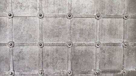Grunge black metal background with symmetrically arranged trim strips. Square grid finish and...
