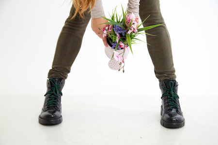 Female winter, autumn or spring black leather shoes on leg of woman in studio on white background. Fashionable modern photography and photoshoot for store, catalog, magazine or onlineの写真素材