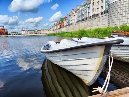 Harbor with wooden boats in city. Embankment of the resort town. Sunny summer day and water landscape in summerの写真素材