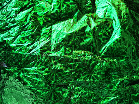 Beautiful abstract background and texture of crumpled aluminum foil in green color. Pattern, place for text and copy spaceの写真素材