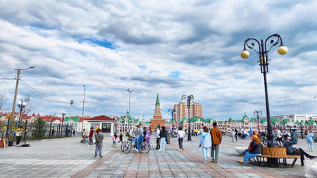Yoshkar-Ola, Republic of Mari El, Russia - April 29, 2023: Tourists on the city street on summer, spring, autumn day on the Bruges embankment. Attraction of Russiaのeditorial素材