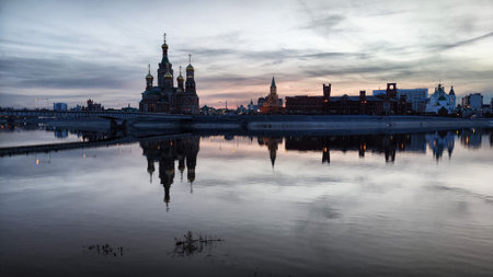Beautiful buildings on the embankment near the water on Bruges embankment in Yoshkar-Ola. Cityscape and landscape in the eveningの写真素材
