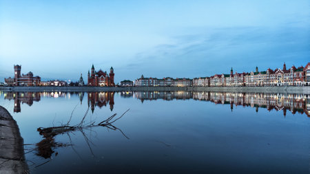 Beautiful buildings on the embankment near the water on Bruges embankment in Yoshkar-Ola. Cityscape and landscape in the eveningの写真素材