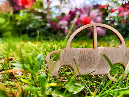 Toy wooden car on grass. The concept of travel, choosing mode of transportation for trip. Travel to natureの写真素材