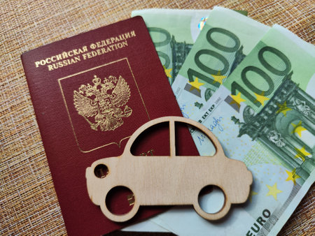 Wooden figurines, Russian citizen passport, Euro banknotes. Concept of traveling and payment. Conflict between Russia and Ukraine, border closures. Expensive cost of traveling for Russians peopleの写真素材