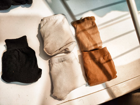 Socks sorted into pairs lie in a pile. Top view. Careful storage of clothes. Clutter and declutter