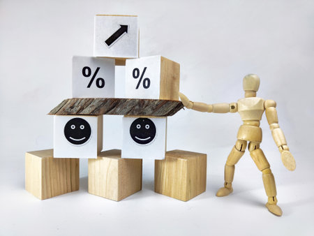 Wooden cubes in a column and row with white signs with a smiley sign, an arrow, a percentage. The...