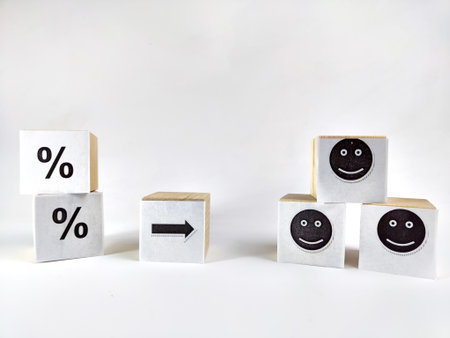 Wooden cubes in a column and row with white signs with a smiley sign, a percentage. The concept of...
