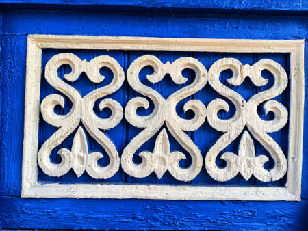 fragment of wooden carved patterns on black background. Windows of wooden houses are decorated with...