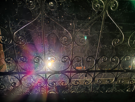wrought iron fence of the railing in night dark black time and lantern as star on background....
