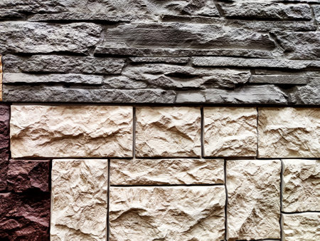 Stylized stone or brick plastic wall of different colors. Abstract Background, Texture, Pattern, frame, place for text and copy spaceの写真素材