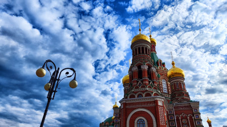 Orthodox church with a dome against the backdrop of a spring or summer sky with clouds. Beautiful old historic templeの写真素材