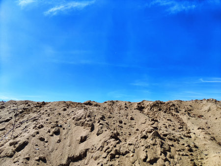 View of high sand dune with footprints and blue sky. Natural location and place for photographyの写真素材