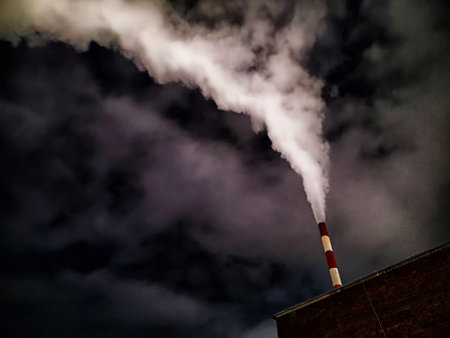 Winter night industrial landscape. Coal-fired power station with smoking chimneys against dramatic dark sky. Carbon dioxide CO2 emissions as primary driver of global climate change. Air pollutionの写真素材