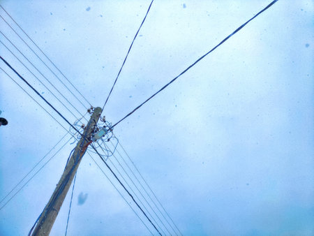 Old pole with wires against the sky. Electric transmission line, Eco-friendly energyの写真素材