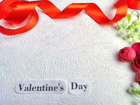 White background, flowers, red ribbon and Valentine's Day inscription. Concept of holiday. Card, Background, Texture, Frame, copy space, place for textの写真素材