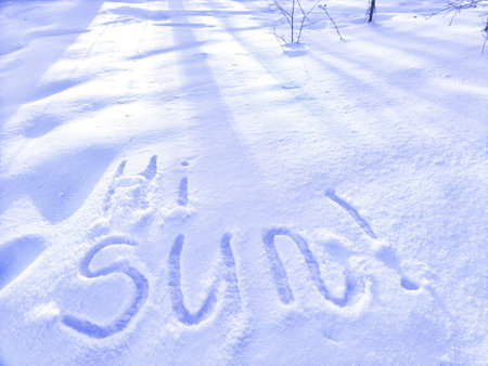 Inscription Hi Summer, written on white background of the snow. Top view. Flat lay. Winter and spring. Waiting for summer and springの写真素材