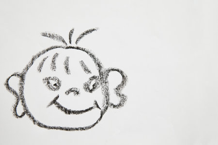 Concept for positive attitude with hand drawn fat tricky child face on white background. Psychology, emotion, smiley face, place for text and copy spaceの写真素材