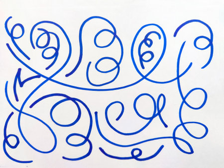 Abstract Blue Pen Doodles on White Paper. Series of whimsical blue ink doodles with loops and swirls...