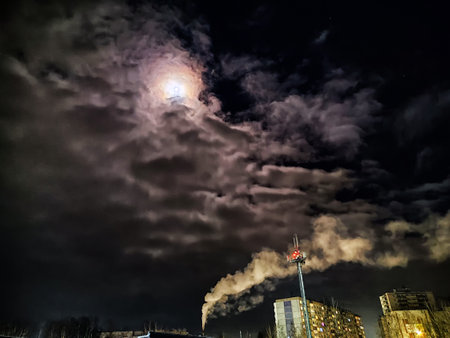 Winter night industrial landscape. Coal-fired power station with smoking chimneys against dramatic dark sky. Carbon dioxide CO2 emissions as primary driver of global climate change. Air pollutionの写真素材